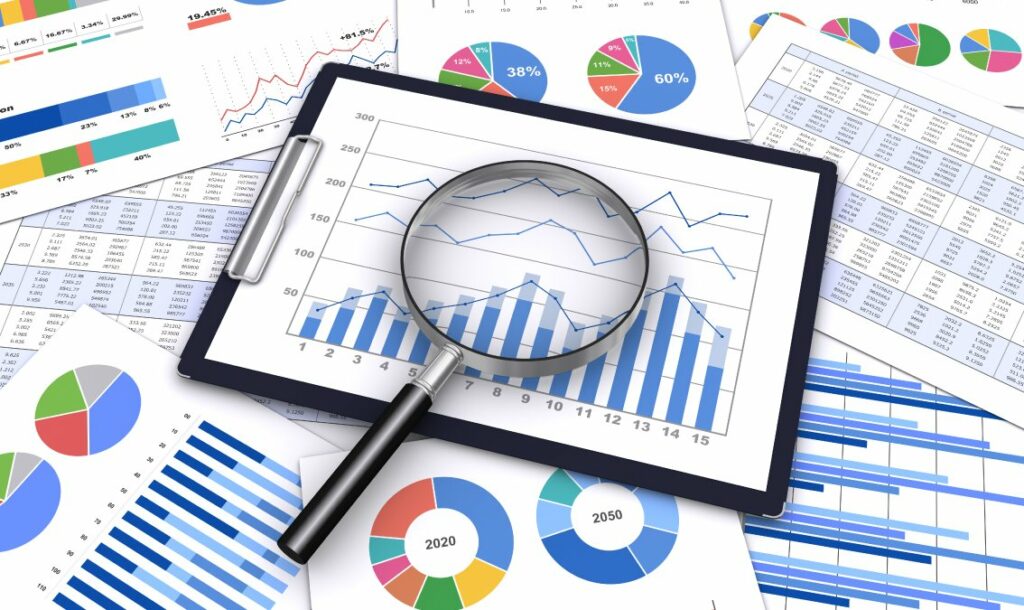 Magnifying glass with data charts and reports