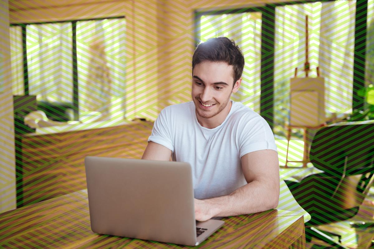 Young man taking an online course on a laptop.