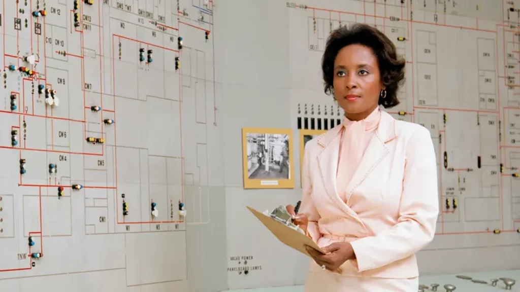 Photo of Annie Easley standing in front of a whiteboard