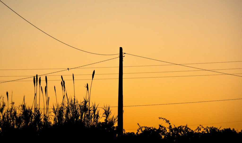 Old telephone lines in the sunset.